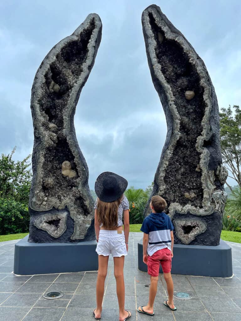 Two children looking at giant crystals at the Crystal Castle Byron Bay