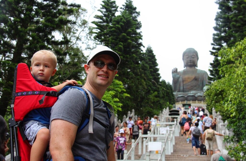 Dad at Big Buddha Hong Kong with toddler in hiking backpack carrier