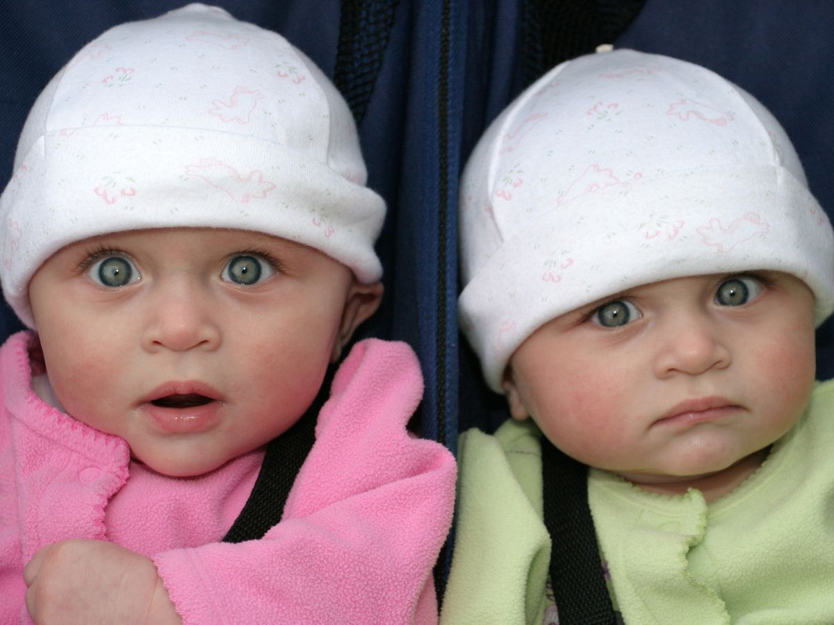 Twins in matching white hats