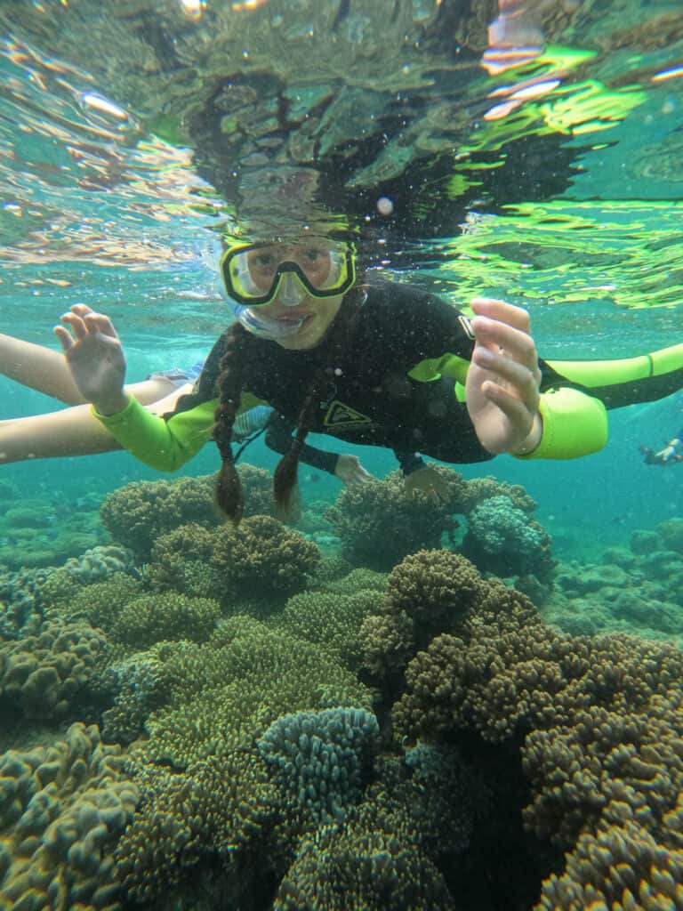 Girl snorkelling on the inner reef at Hook Island. 