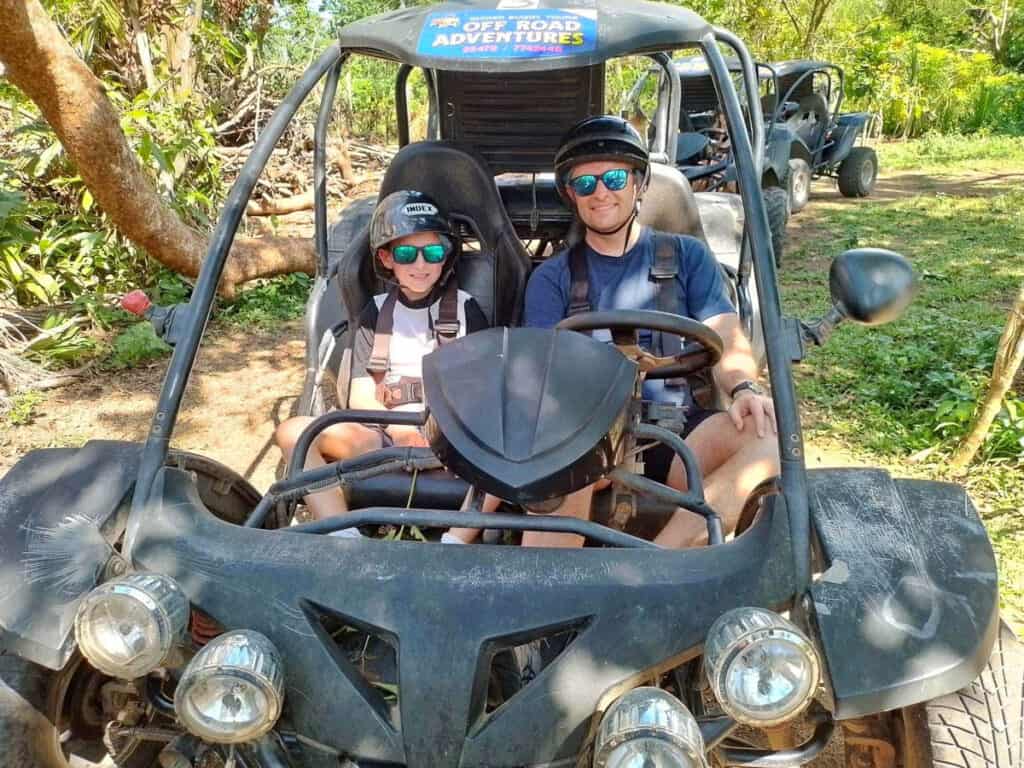 Father and son in off road buggy at Off Road Adventures Port Vila, Vanuatu.