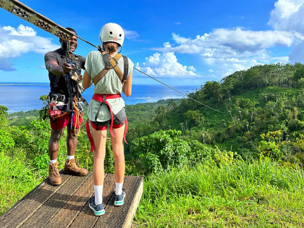 Girl and instructor getting ready to zip line in Port Vila, Vanuatu.