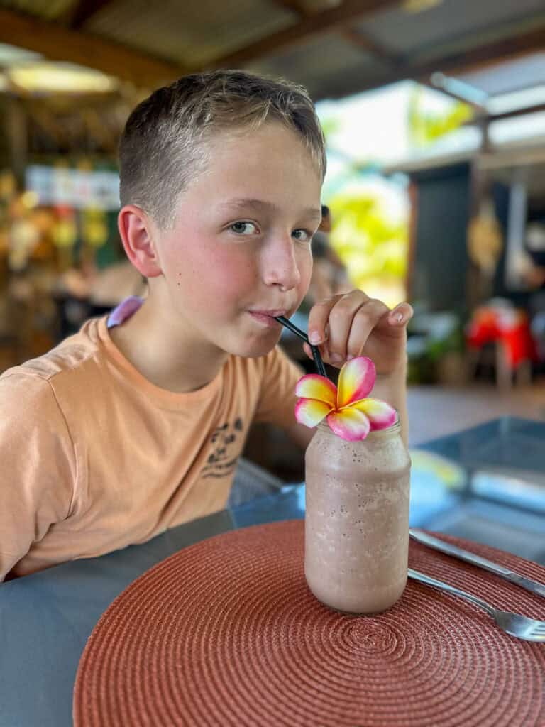 Boy drinking a smoothie in the Cook Islands.