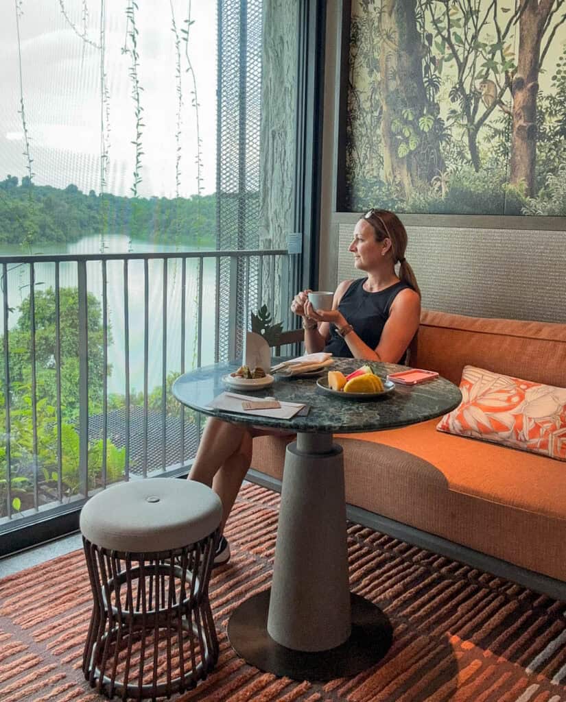 Woman lounging and looking at the view at Mandai Rainforest Resort.