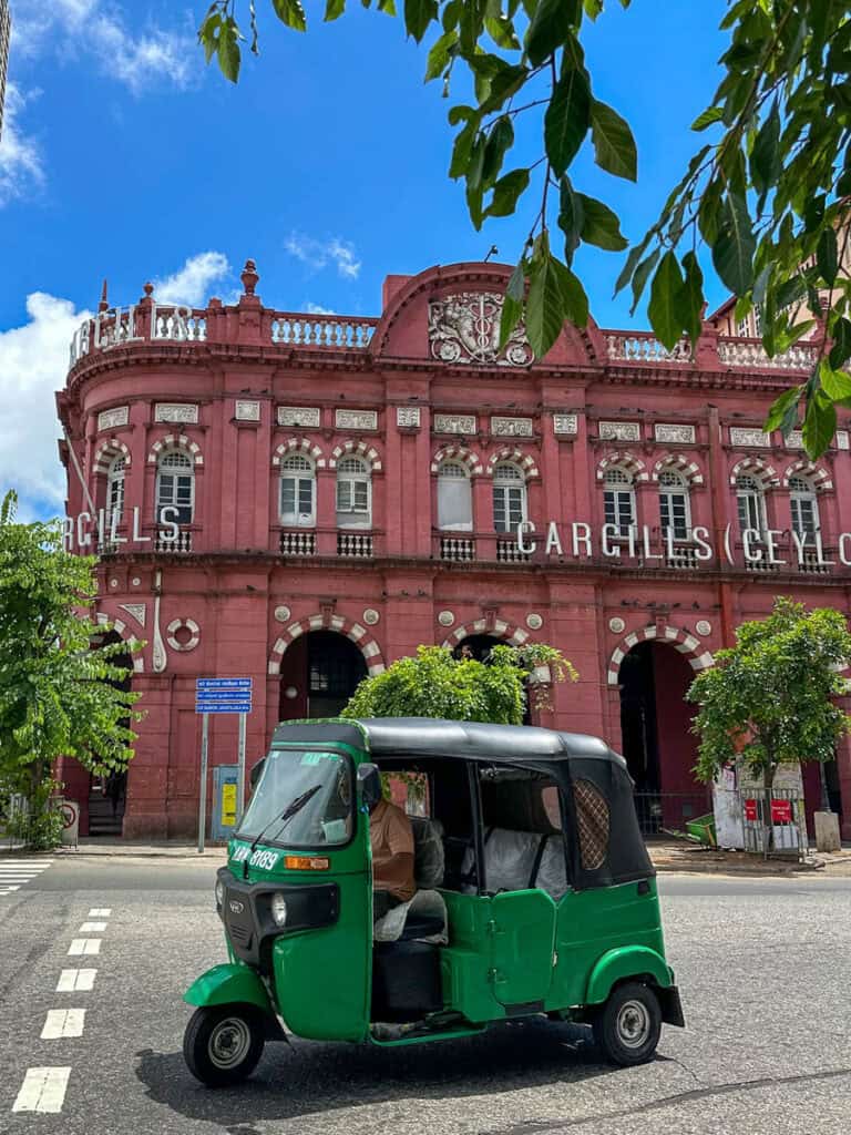 Colonial building and tuk tuk in Colombo, Sri Lanka.