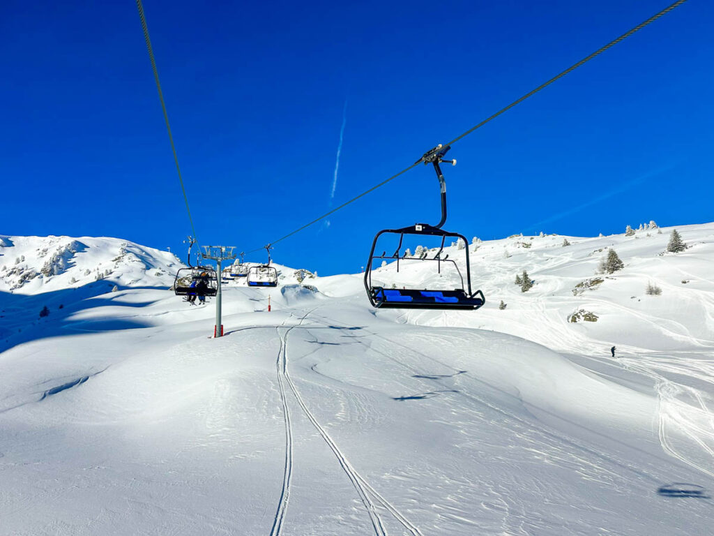 Chairlift over snowy slopes in Les Arcs, France.