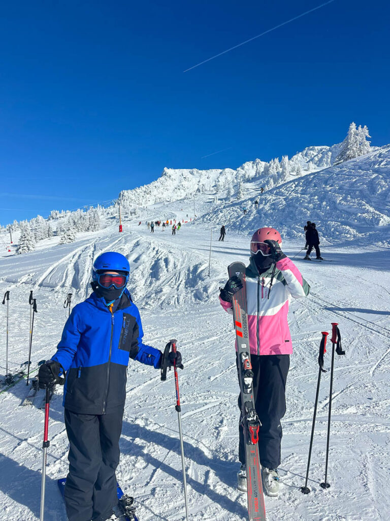 Kids with skis on the slopes in Les Arcs, France.